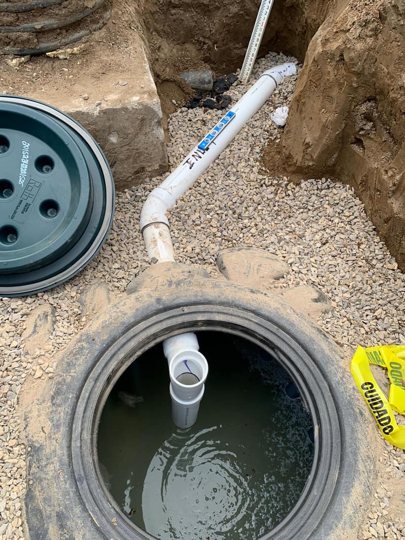 Properly sealed septic riser opening with clean pipework visible inside