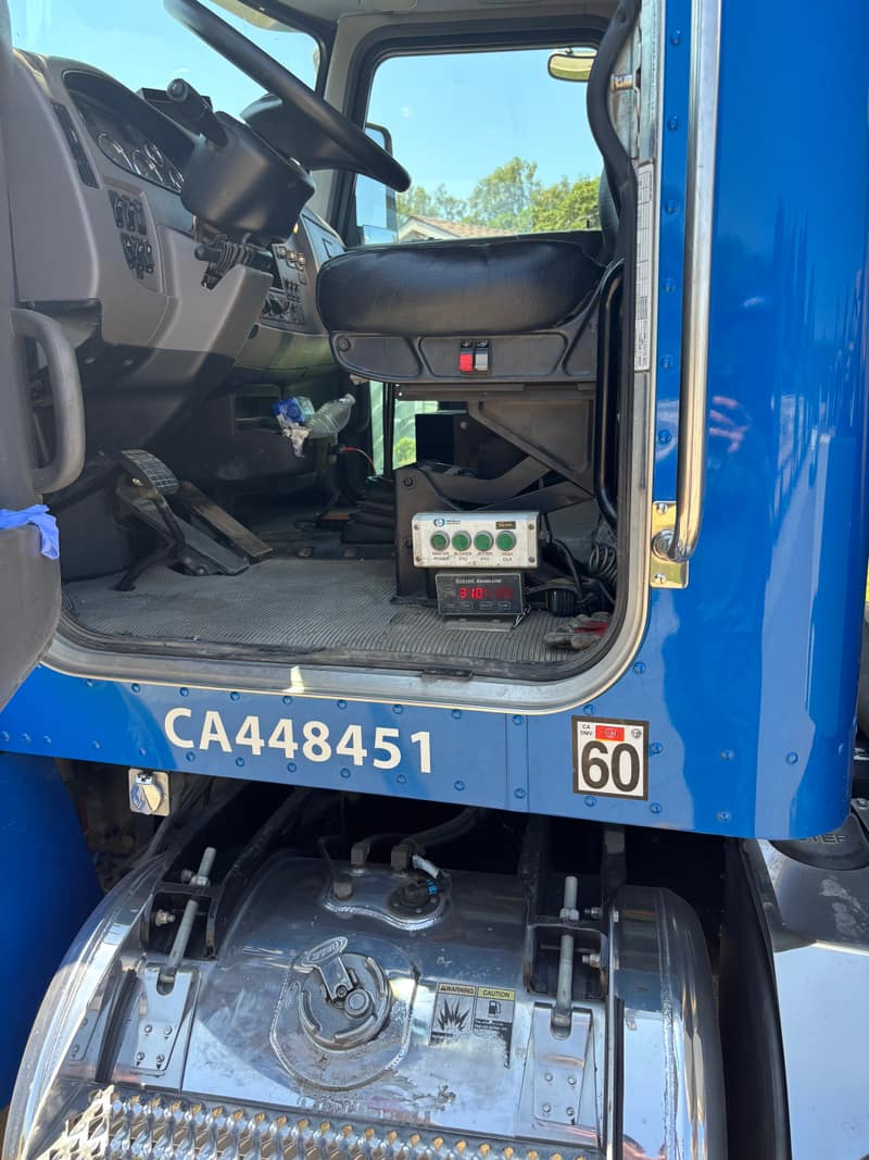 Gallon meter and controls on the side of a blue pump truck