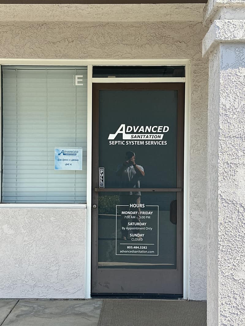 Front door of the Advanced Sanitation office with the company logo on the glass